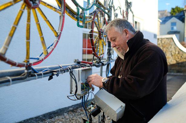 Angarrack resident Chris Bray attends to one of the many Christmas lights in the village (Image: Greg Martin / Cornwall Live)